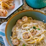 Creamy one-pan shrimp fettuccine Alfredo topped with parsley in a skillet