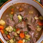 Bowl of easy beef stew with vegetables and herbs
