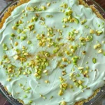 Slice of easy pistachio cream pie with a nutty crust and green filling