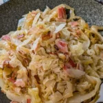 Sautéed cabbage with bacon and onions served in a skillet