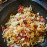 Plate of sauteed cabbage with onions and bacon cooked to perfection