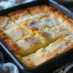 Classic French butter cake served with fresh fruits on a rustic wooden table