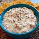 Cream Cheese Sausage Dip served in a bowl with crackers and vegetables