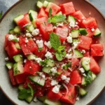 Fresh watermelon salad with feta cheese garnished with mint leaves