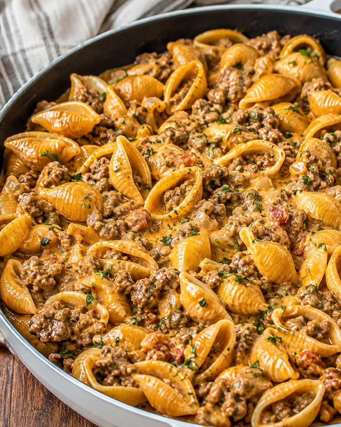 Silky Beef and Shell Pasta served in a bowl, garnished with herbs.