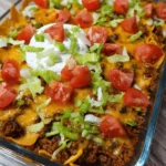 One-Pan Taco Casserole with cheese and toppings in a baking dish