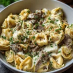 Plate of Philly-Style Tortellini with Cheesesteak, showcasing gourmet flavors.