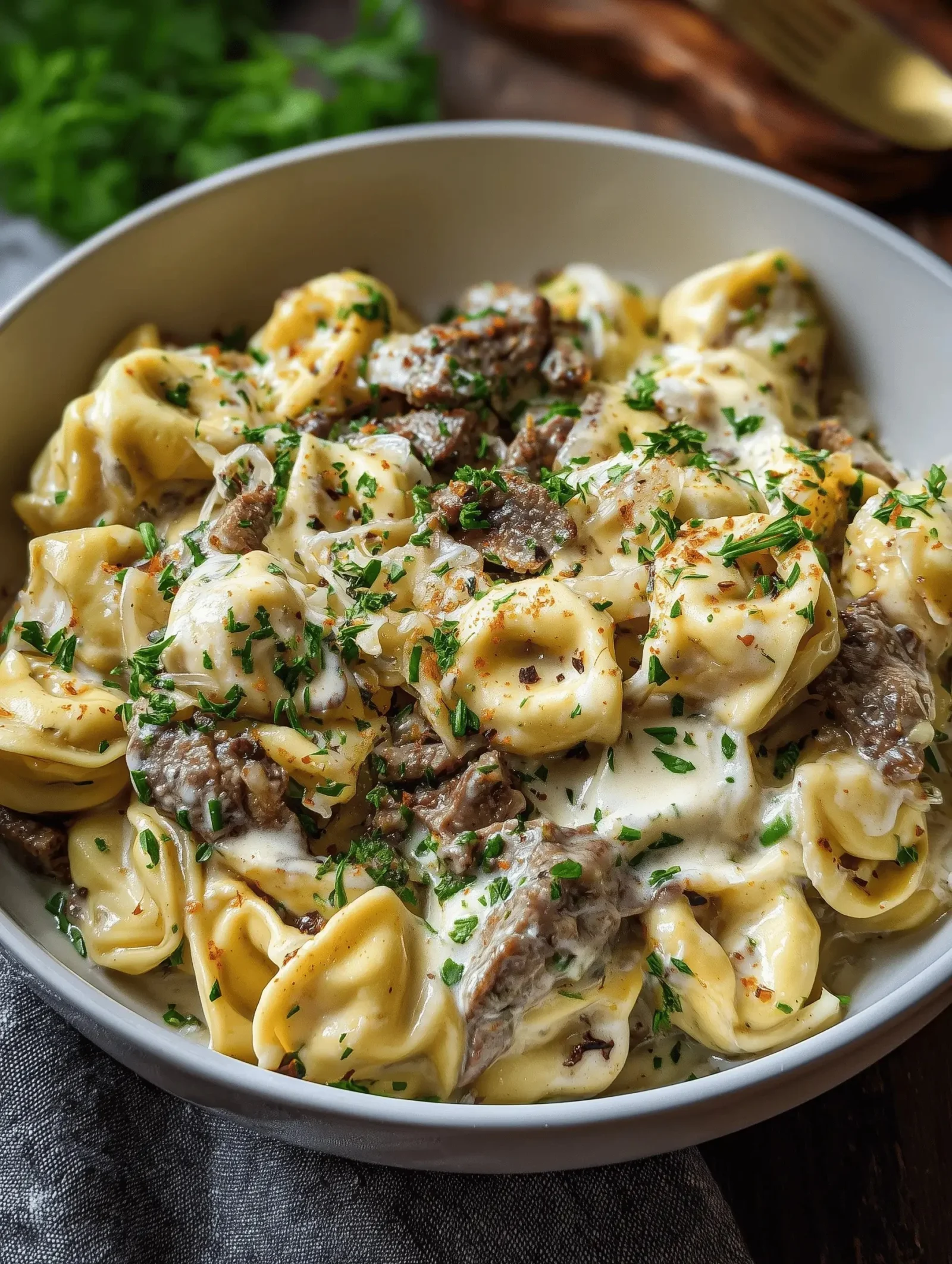 Plate of Philly-Style Tortellini with Cheesesteak, showcasing gourmet flavors.