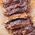 Delicious BBQ Pork Ribs grilled to perfection, garnished with fresh herbs.