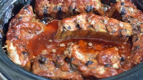 Delicious crock-pot barbecue ribs served with side dishes