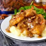 Delicious Maple Bourbon Pecan Chicken garnished with pecans and maple glaze.