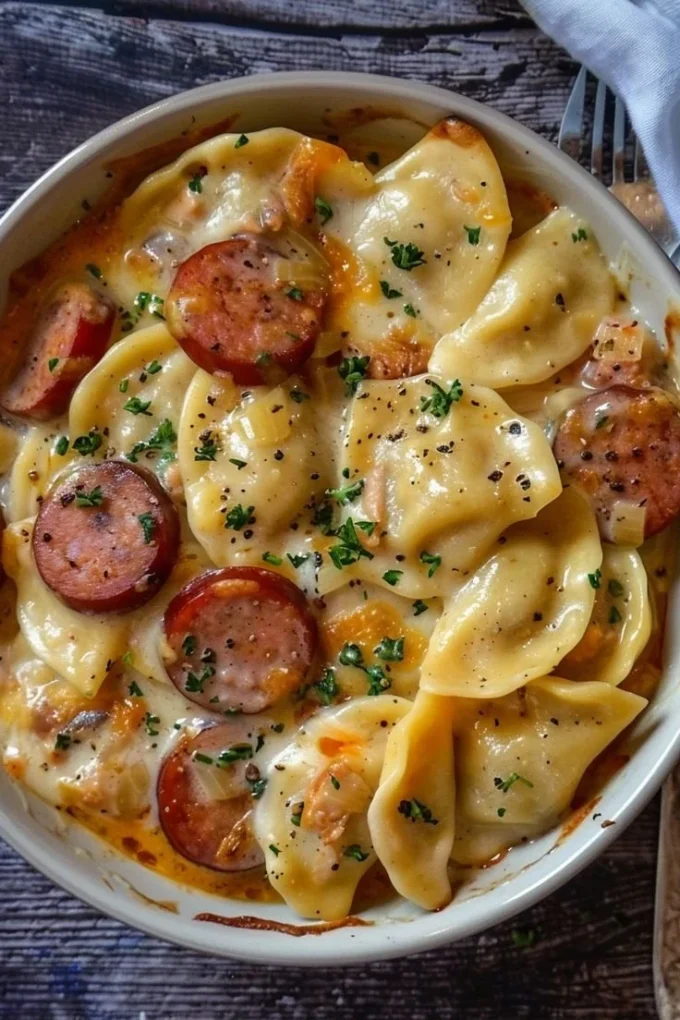 Delicious slow cooker pierogi casserole with kielbasa, topped with cheese.